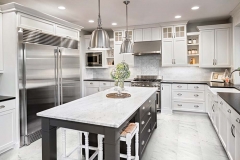 Beautiful Kitchen in Luxury Home with Island and Stainless Steel Refrigerator